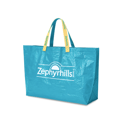 Blue reusable tote bag with yellow handles and "Zephyrhills" logo in white, featuring a sun design on the front.